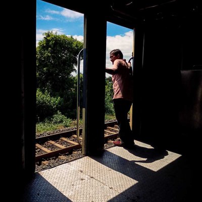 A traveller waiting for the train to arrive in the station