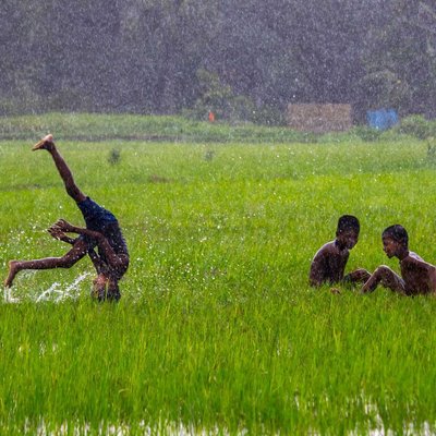 Boys, enjoying the heavy monsoon rain.