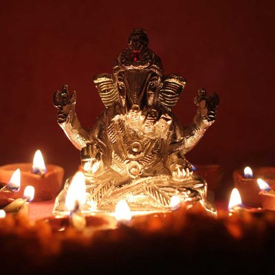 lord Ganesha with illuminating oil lamp