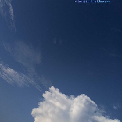 Beneath the blue sky.