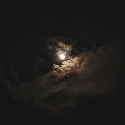The moon shining bright against the dark night sky