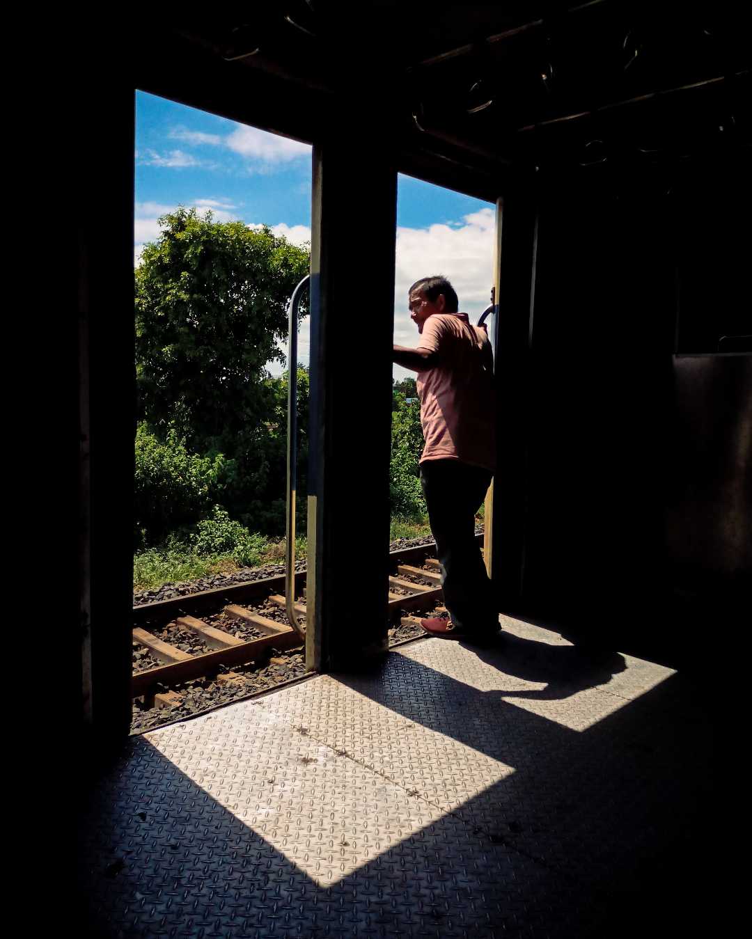A traveller waiting for the train to arrive in the station