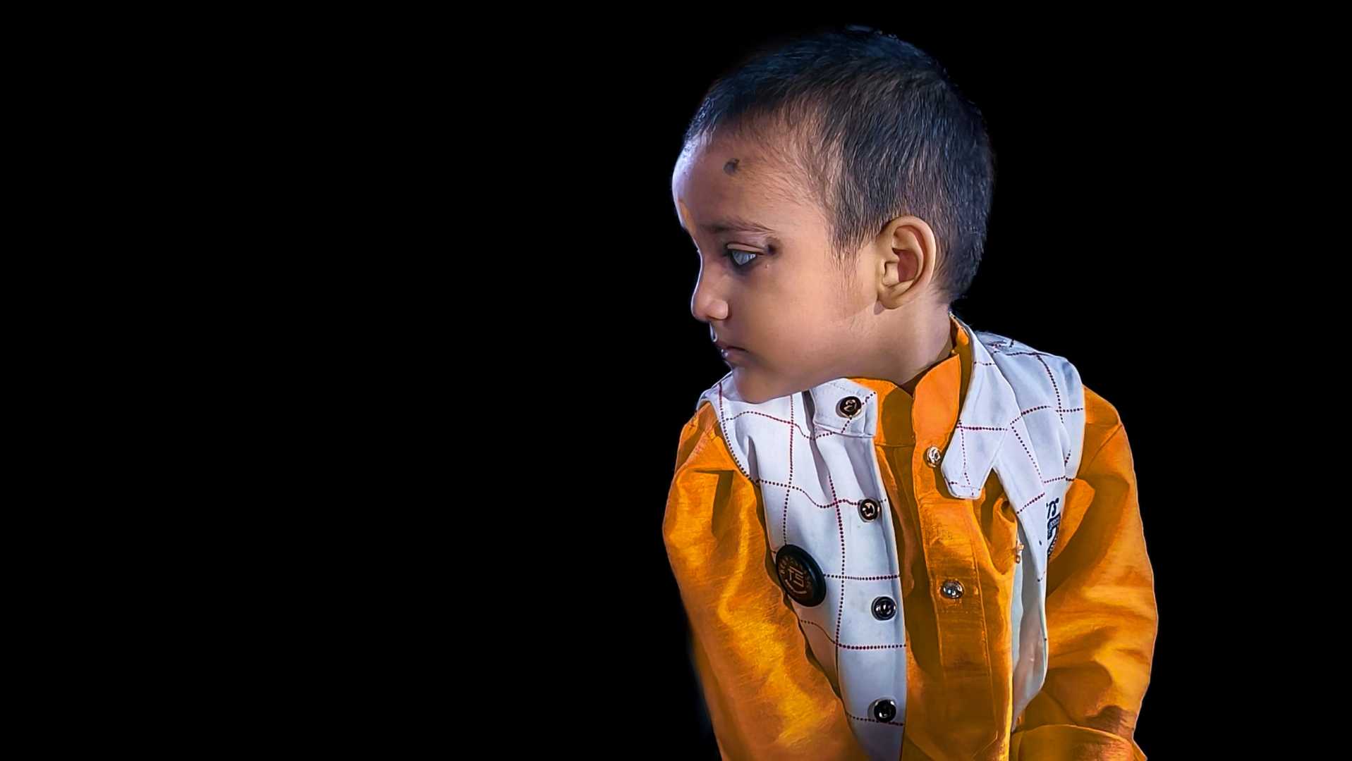Random kid portrait with black background 