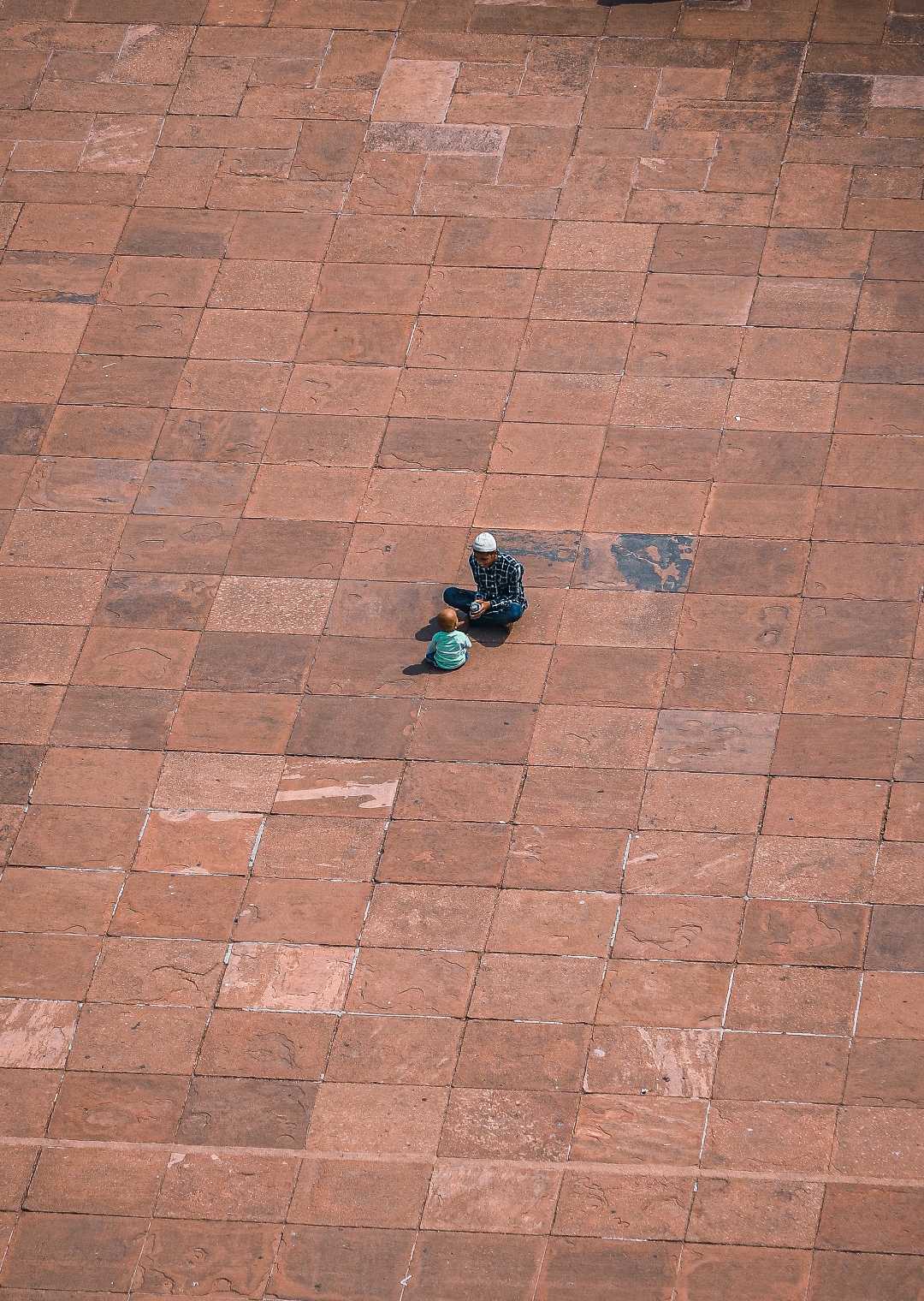 minimal photography of father and son in Jama Masjid,  Delhi