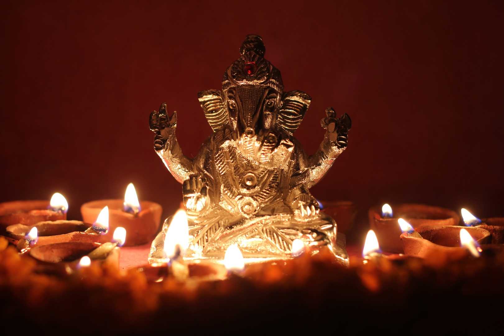 lord Ganesha with illuminating oil lamp