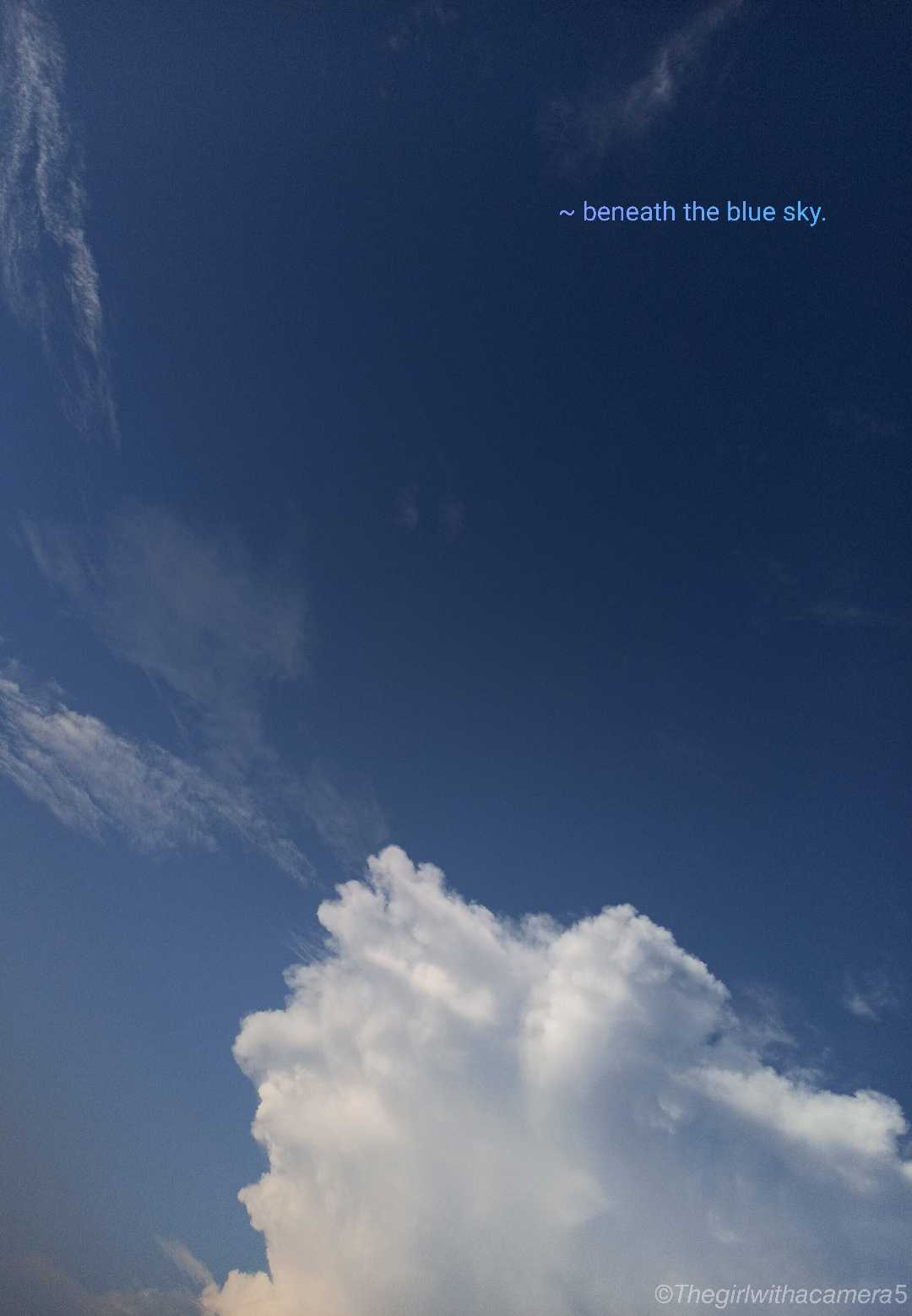 Beneath the blue sky.