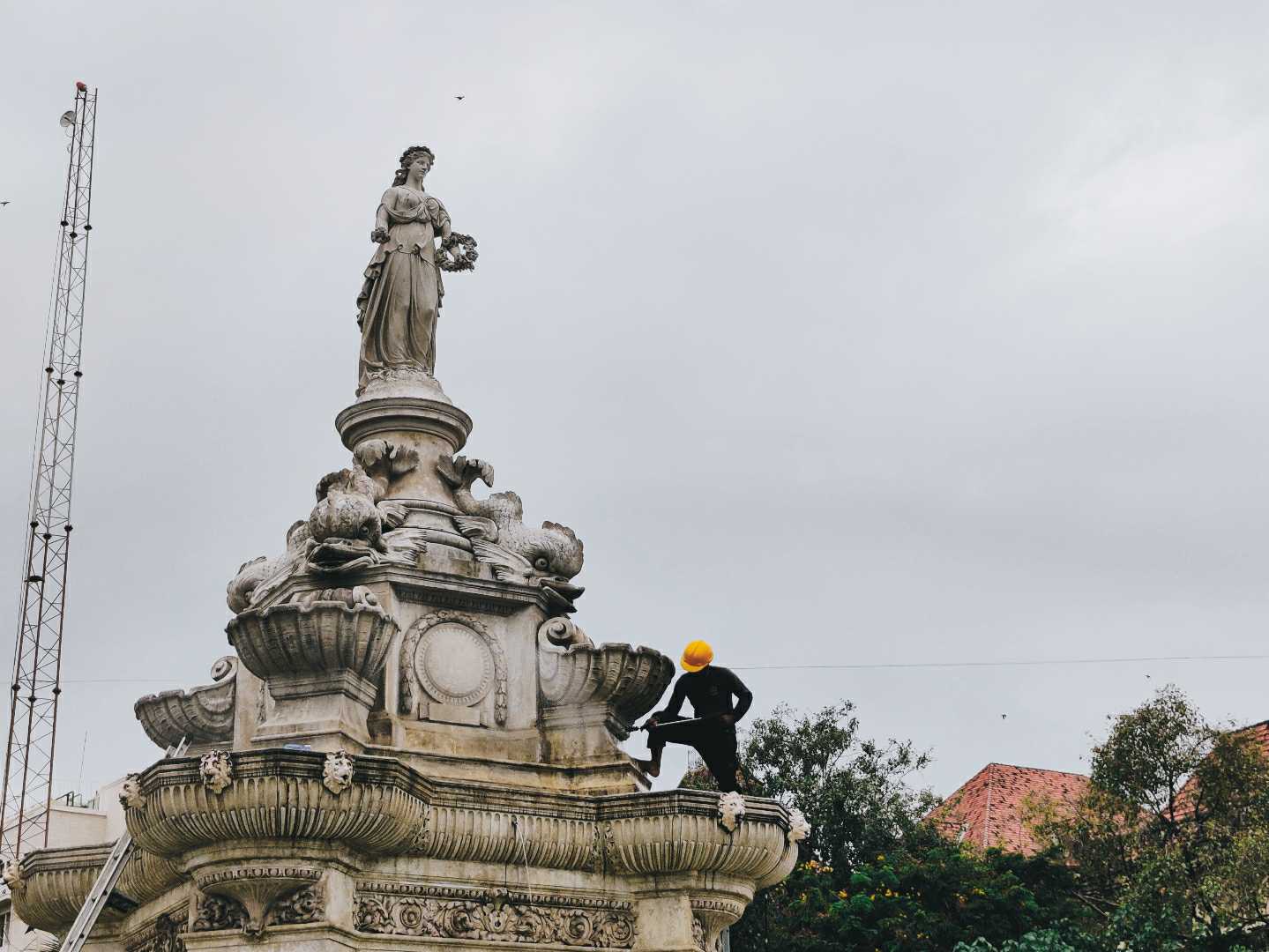 A Worker cleaning up the Beautiful Flora Fountain 